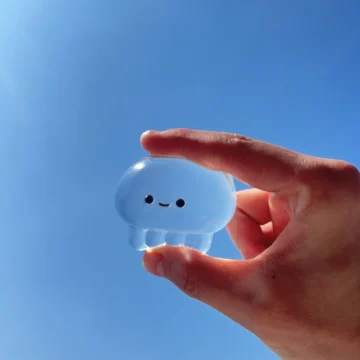 Clear Jellyfish Taba Squishy Toy being squeezed by hand