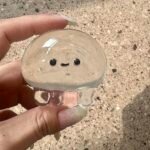 Clear Jellyfish Taba Squishy Toy being squeezed by hand