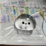 Clear Jellyfish Taba Squishy Toy being squeezed by hand