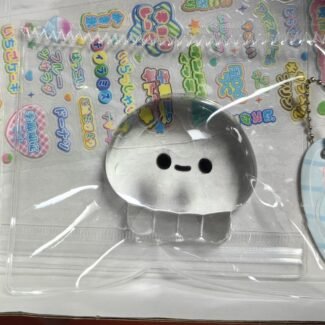 Clear Jellyfish Taba Squishy Toy being squeezed by hand