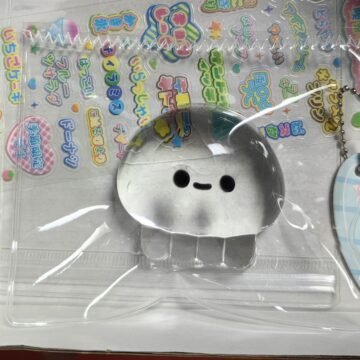 Clear Jellyfish Taba Squishy Toy being squeezed by hand