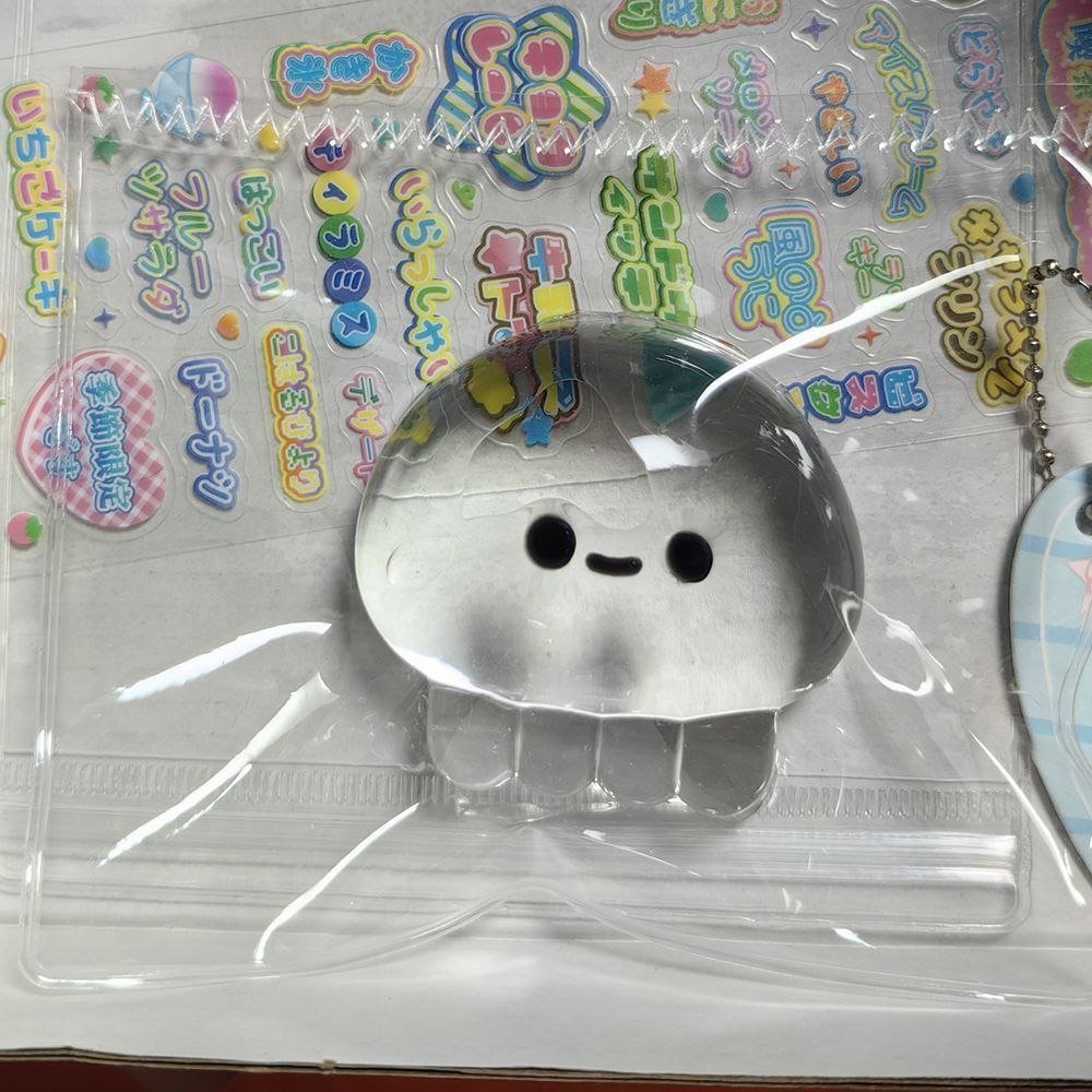 Squishy Toy2 Clear Jellyfish Taba Squishy Toy being squeezed by hand