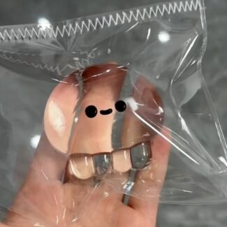 Clear Jellyfish Taba Squishy Toy being squeezed by hand